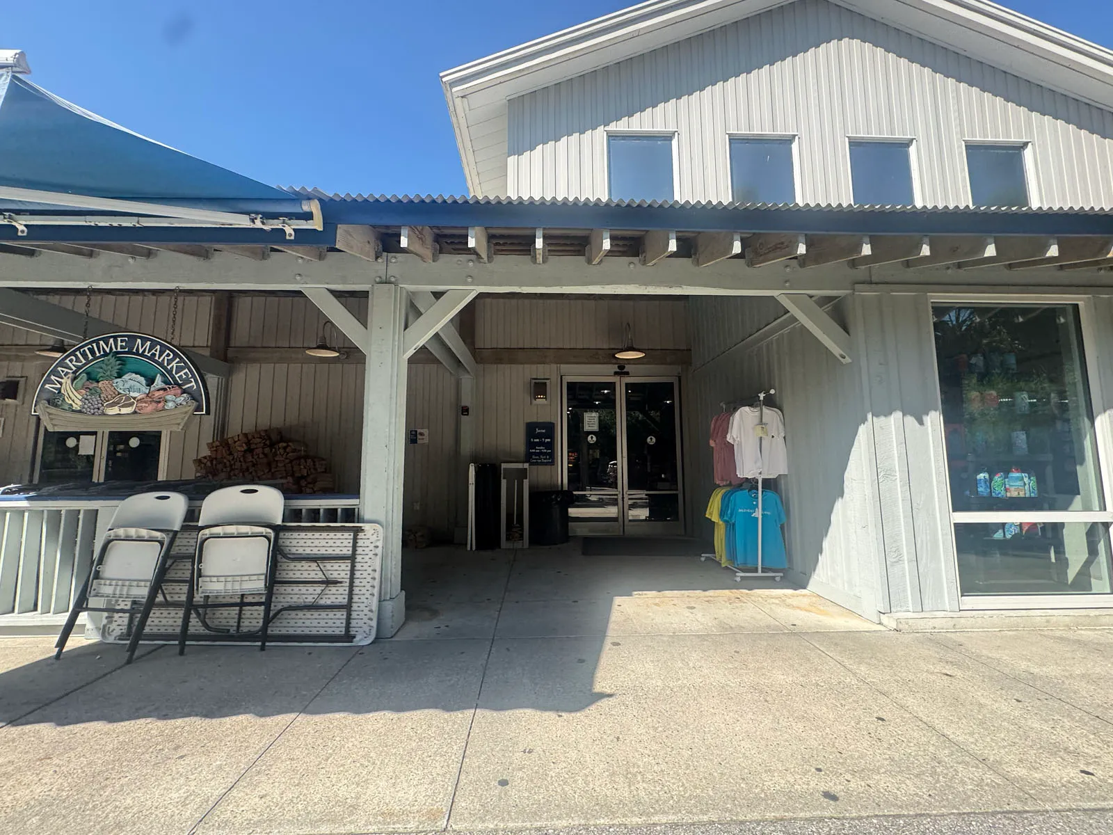 Maritime Market storefront with sign and apparel rack