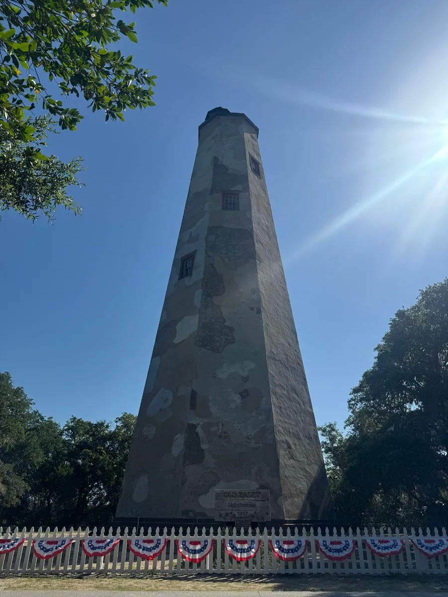 Full Old Baldy tower with weathered stucco and picket fence